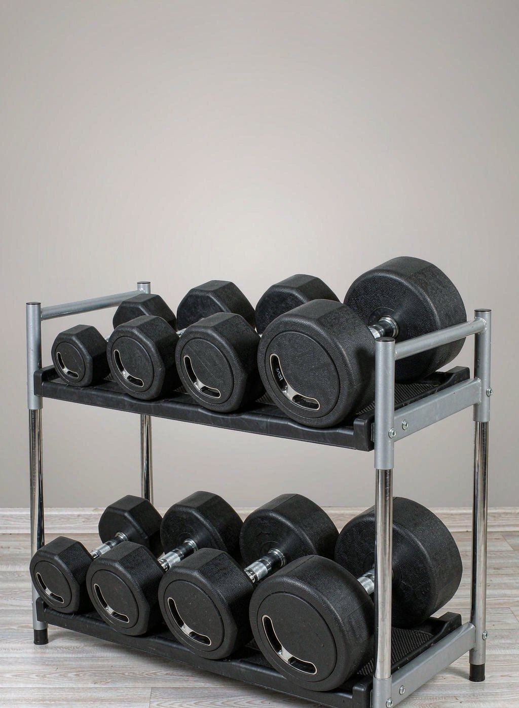 Black hex dumbbells on a two-tier steel rack
