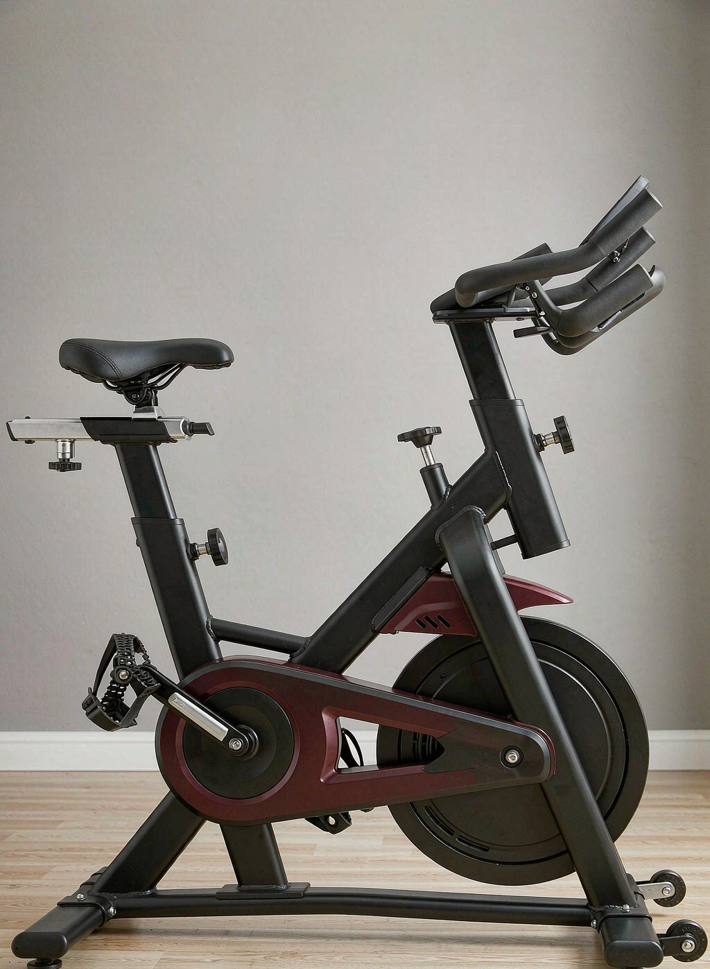 Matte black spin bike with a red flywheel accent