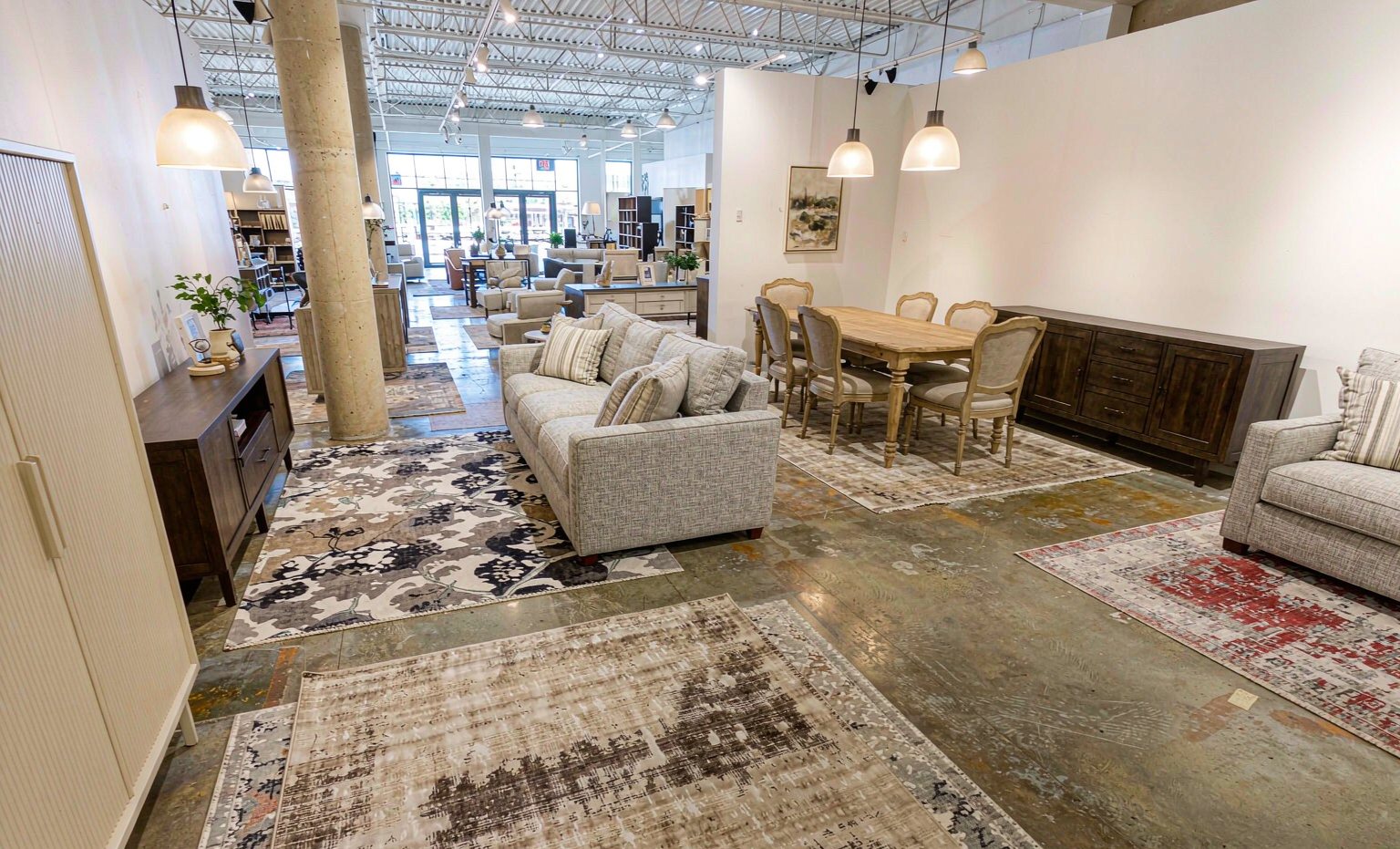 Bright furniture showroom with sofas and dining sets